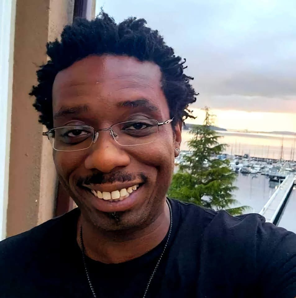 TerRon Rathe, founder of Rathe TEC, smiling on a marina balcony with boats in the background